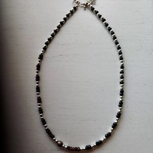 Handmade Black and Silver Beaded necklace. Balanced, minimalist aesthetic.